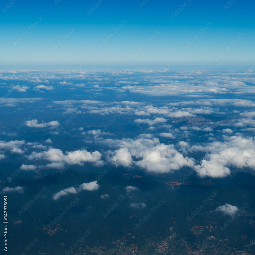 Blue sky with white clouds, view from a flying airplane. Blue sky with white clouds, view from a flying airplane.