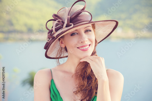 Success. Portrait close up side profile happy serious young beautiful happy confident business woman looking at yol. Positive human emotions facial expressions, attitude. Lady in hat by the sea. photo