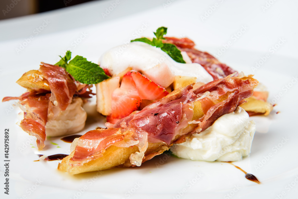 Baguette pieces covered with grilled bacon on plate served luxury.