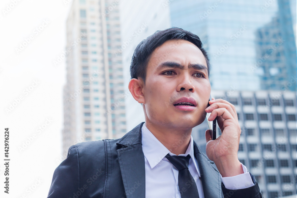 Portrait of businessman talking with smartphone have failed in downtown with building background Portrait of businessman talking with smartphone have failed in downtown with building background
