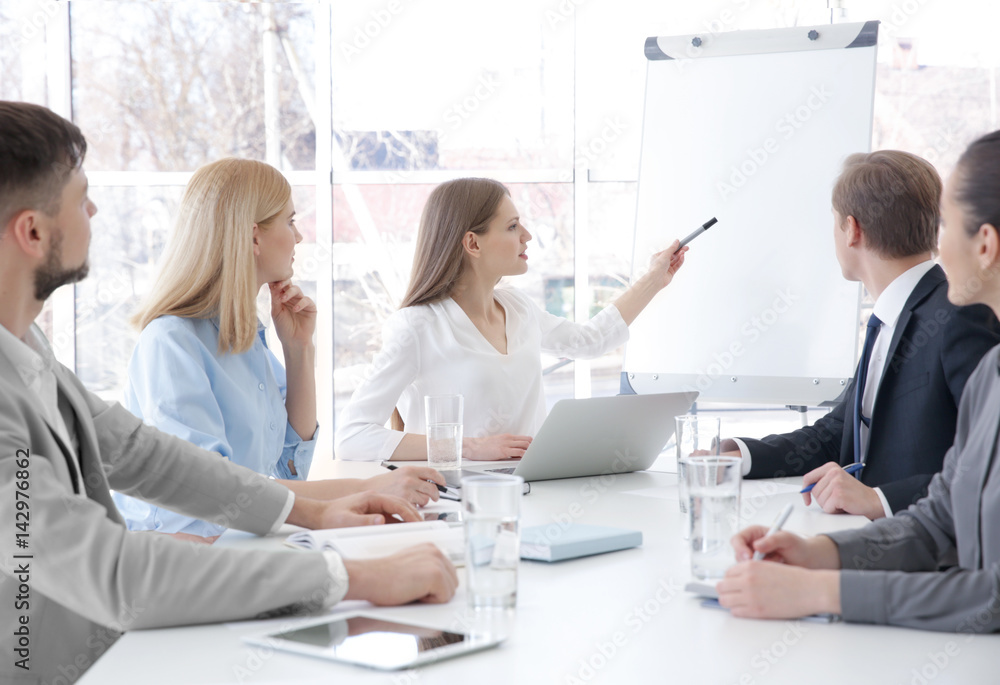 Business trainer giving presentation to group of people Business trainer giving presentation to group of people