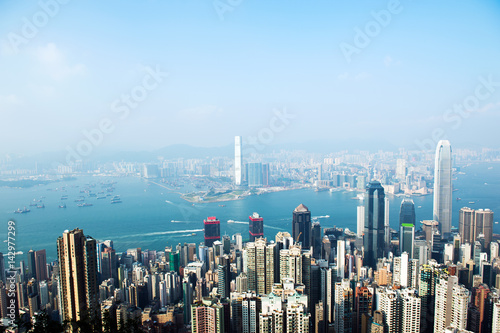 Hong Kong cityscape with victoria harbour and large group of tall buildings.
