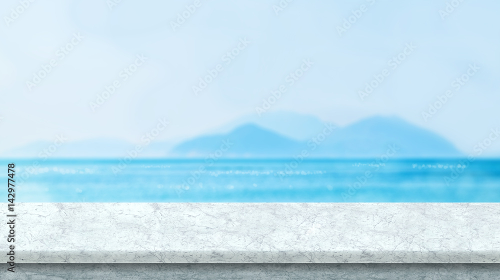 White marble table top with blurred bokeh sea and blue sky at background, Mock up template for display or montage of your product, Summer vacation concept,panorama view