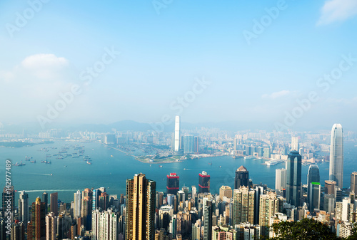 Hong Kong cityscape with victoria harbour and large group of tall buildings. © xy