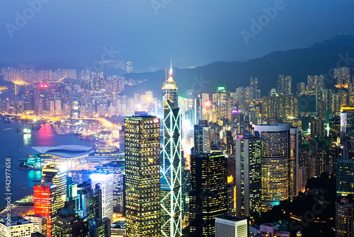 Photography Hong Kong cityscape at night with victoria harbour and large group of tall buildings