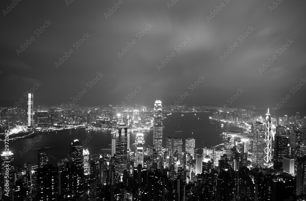 Hong Kong cityscape at night with victoria harbour and large group of tall buildings. Hong Kong cityscape at night with victoria harbour and large group of tall buildings.