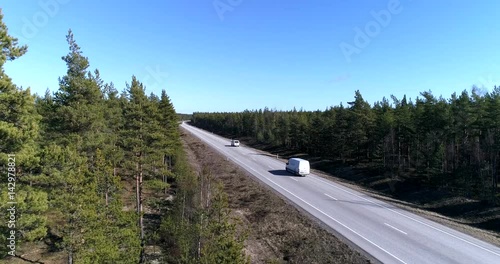 Route 25, Cinema 4k sideway aerial revealing cars driving on route 25, on a sunny spring day, in Hanko, Finland photo