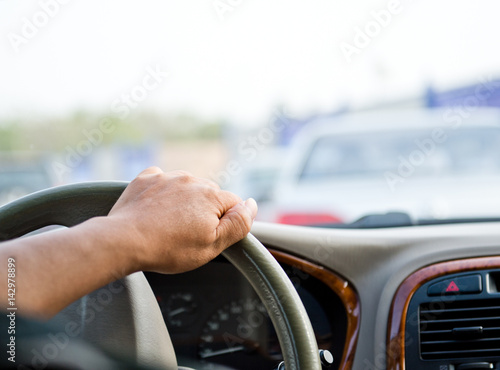 Wallpaper Mural Human hand on steering wheel inside of a car. Torontodigital.ca