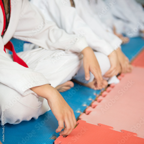 Group of taekwondo trainer sitting on floor for a rest.