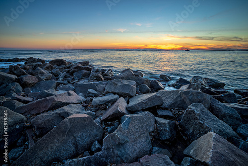 Waves and a jetty at sunset in the Atlantic Ocean at Edisto beach south carolina