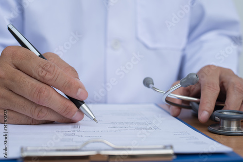 Doctor writing health checklist