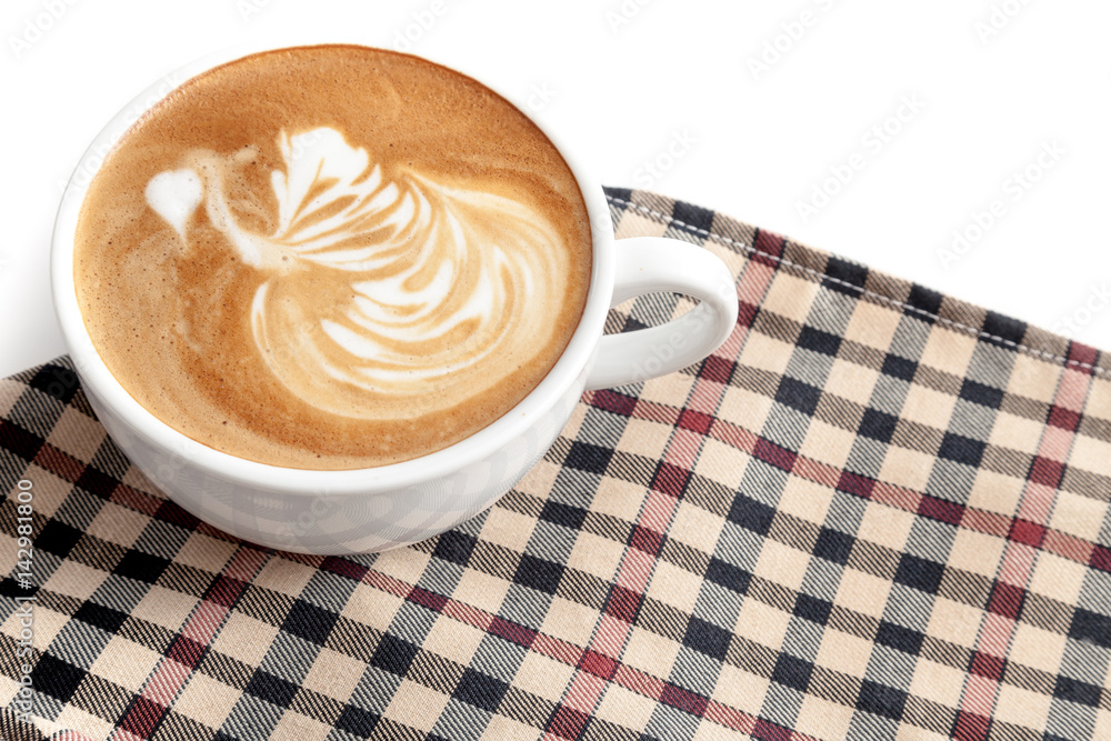 Coffee cup of latte art swan shape on the napkin with some copy space
