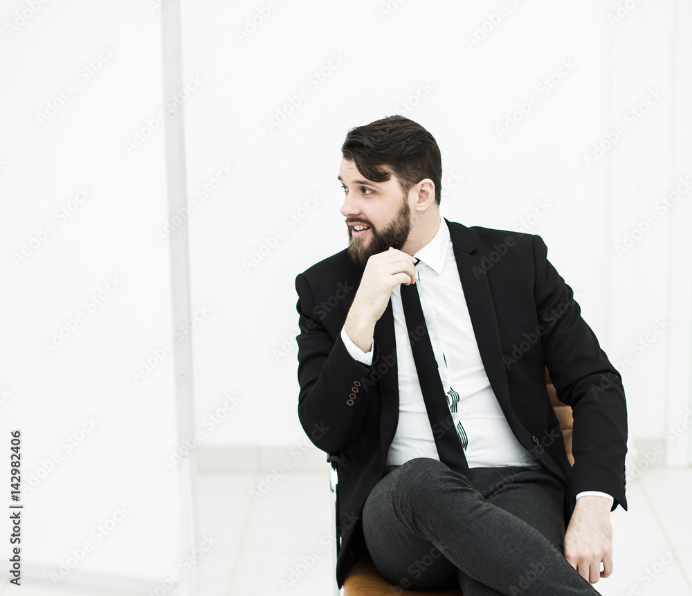successful businessman in a business suit sitting on office chair successful businessman in a business suit sitting on office chair