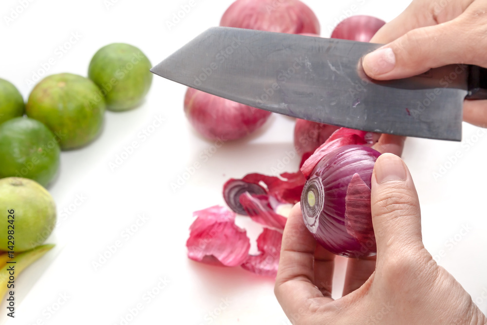 Peeling shallots beside with limes, prepare for cooking
