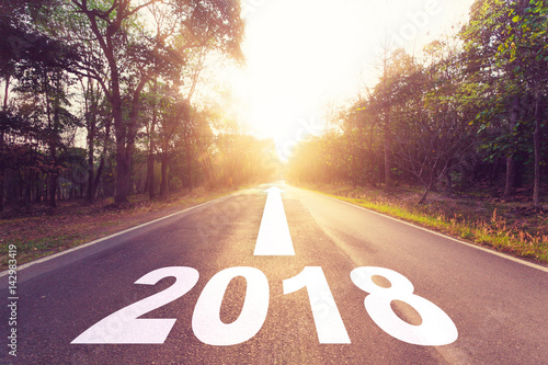 Empty asphalt road and New year 2018 goals concept.