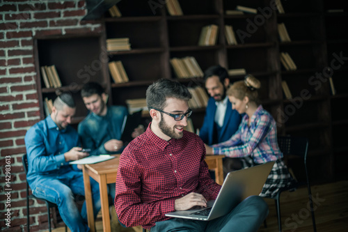 officer of the company with laptop on the background of business