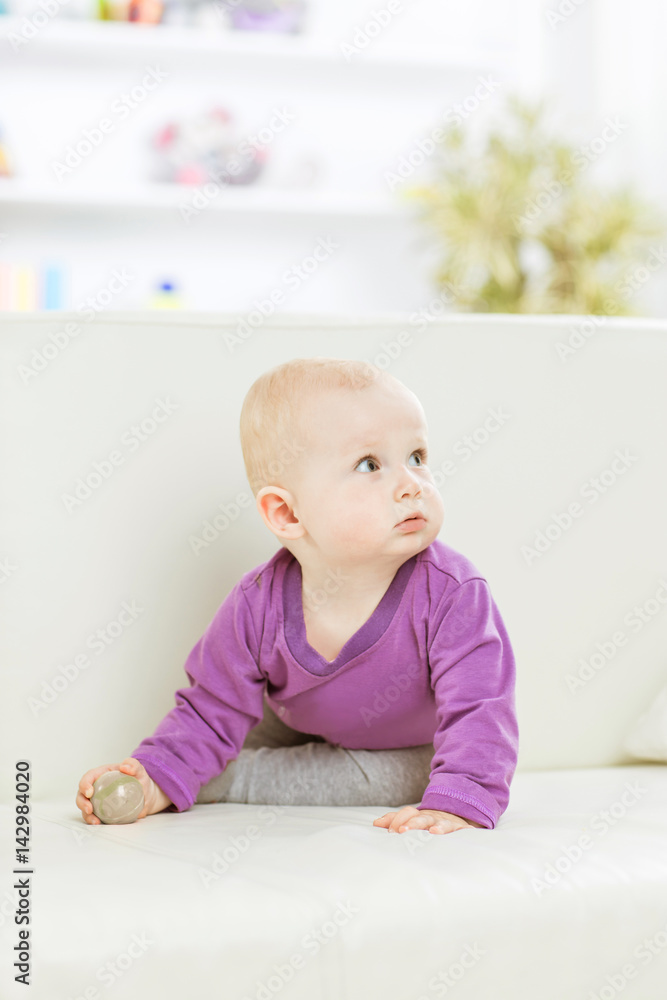 portrait of a happy one year old baby girl on a background of bright children's room portrait of a happy one year old baby girl on a background of bright children's room