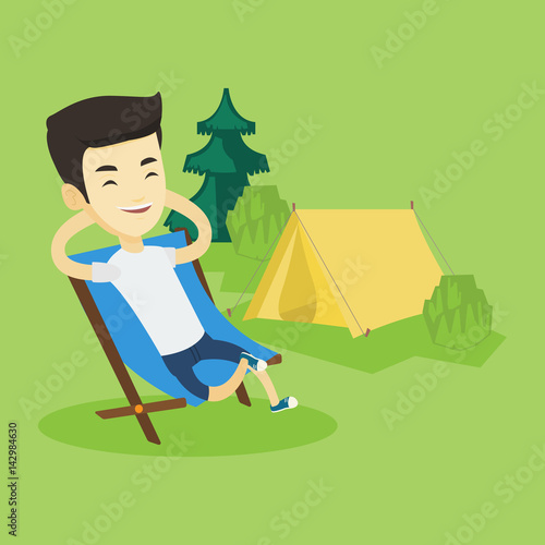 Man sitting in folding chair in the camp.