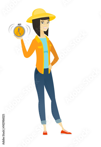 Asian farmer holding alarm clock.