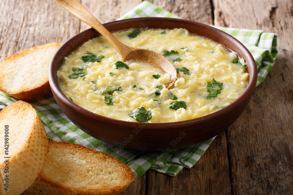 Italian food: soup stracciatella with farfalline and cheese close-up. horizontal Italian food: soup stracciatella with farfalline and cheese close-up. horizontal