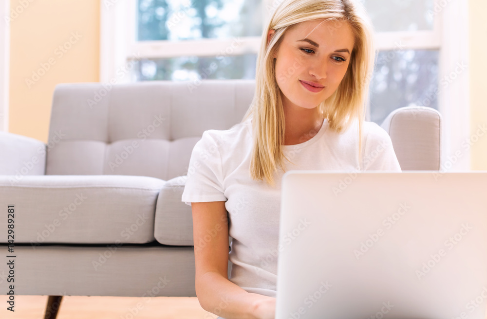 Happy young woman using her laptop Happy young woman using her laptop