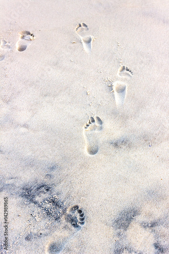 Foot prints left on tthe beach sand photo