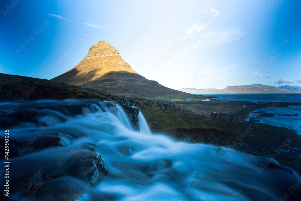 Kirkjufell is a free standing mountain of the Snaefellsnes peninsula, on the northern coast of Iceland. Together seen with the mountain, is a waterfall called Kirkjufellsfoss that flows into the sea.