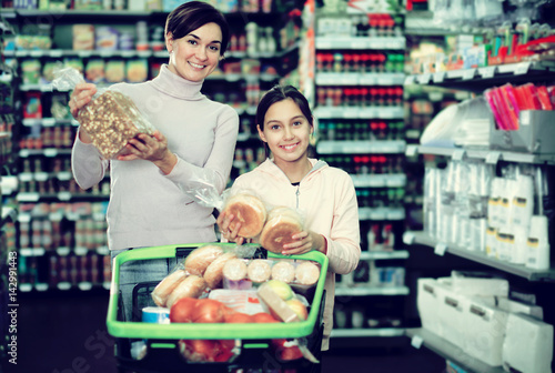 Woman with teenage daughter searching for bread