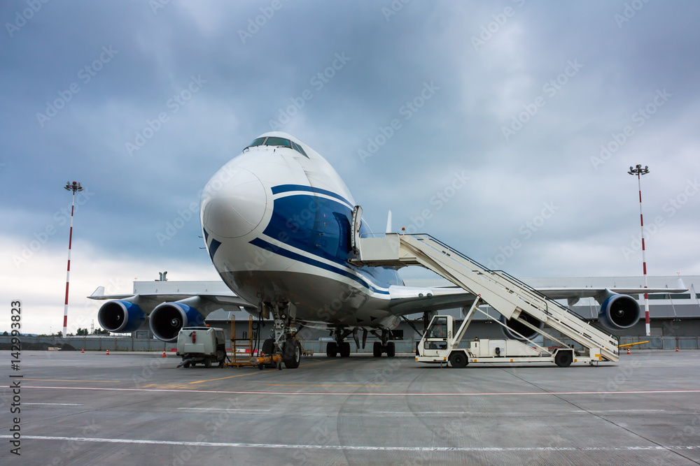 Cargo wide body plane and aircraft passenger loader near terminal Cargo wide body plane and aircraft passenger loader near terminal