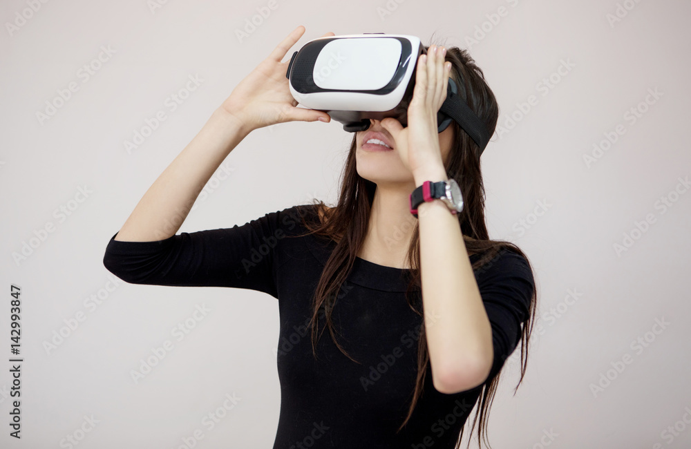 Happy woman wearing virtual reality goggles Happy woman wearing virtual reality goggles