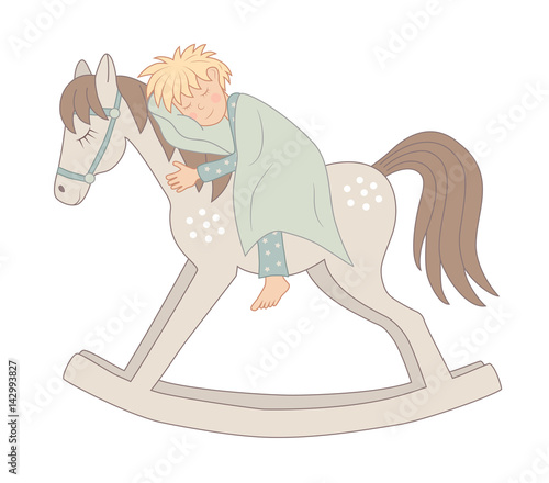 Fotografie little boy sleeping on a rocking-horse
