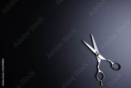 Stylish Professional Barber Scissors, Hair Cutting on black background. Hairdresser salon concept, Hairdressing Set. Haircut accessories. Copy space image, flat lay.