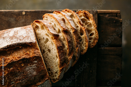 Close up of rustic bread loaf on wooden table photo