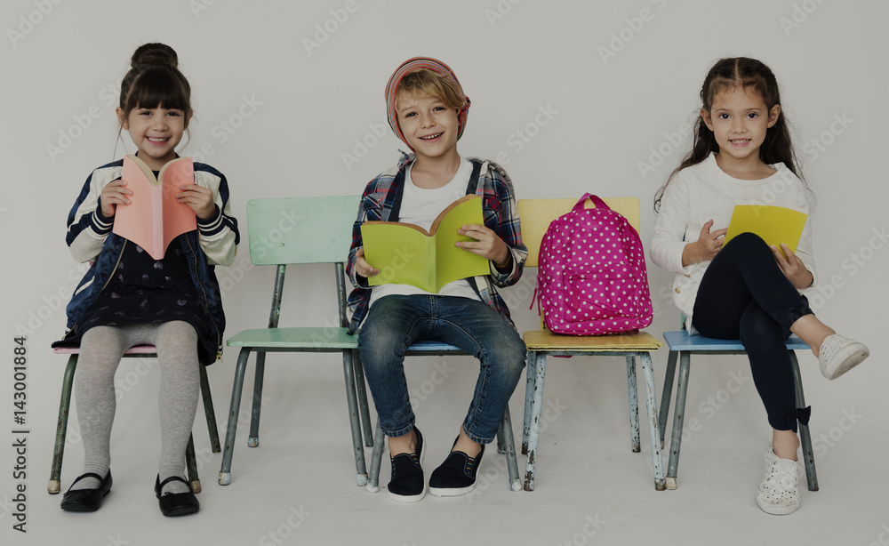 Obraz premium Group of Students Reading Book Sitting on the Chair