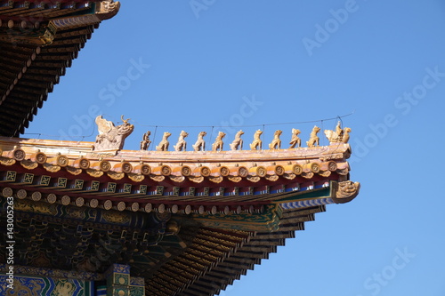 Tiled roof and facade decorated with a Chinese pattern. Palace in The Forbidden City, Beijing, China