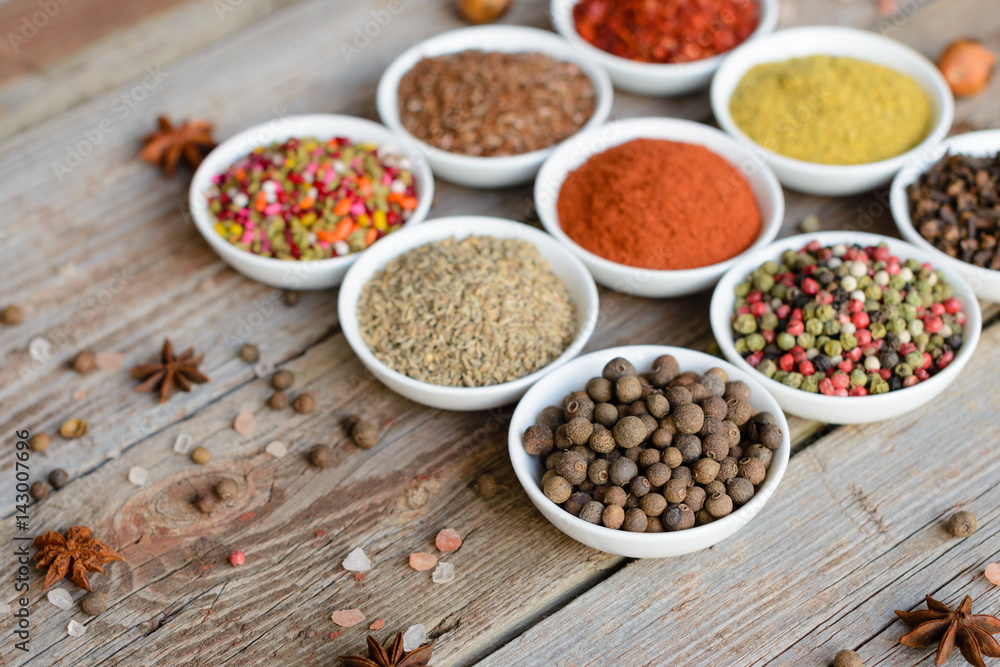 Various spices on wooden spoons. Food ingredients