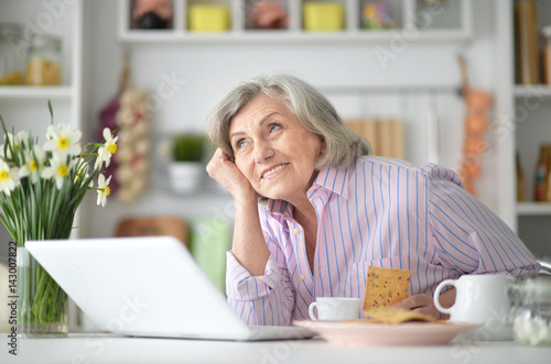 Portrait of an elderly woman having breakfast