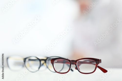 Closeup view of modern glasses on blurred background