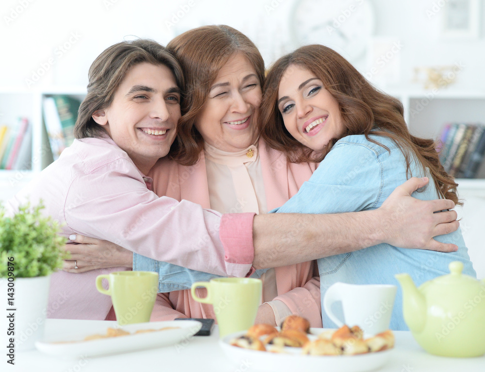 Happy family drinking tea together