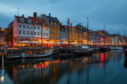 COPENHAGEN, DENMARK - 25 JUN 2016: Fairy tale Nyhavn canal at blue hour, illumanated houses and street