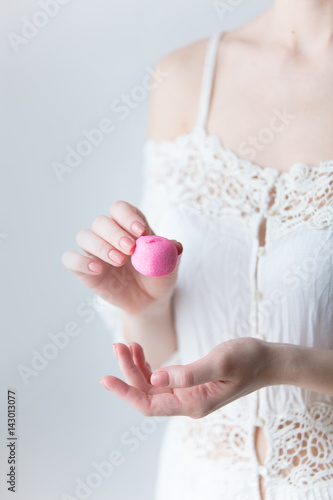 photo of young woman holding pink marshmallow on the wonderful white background