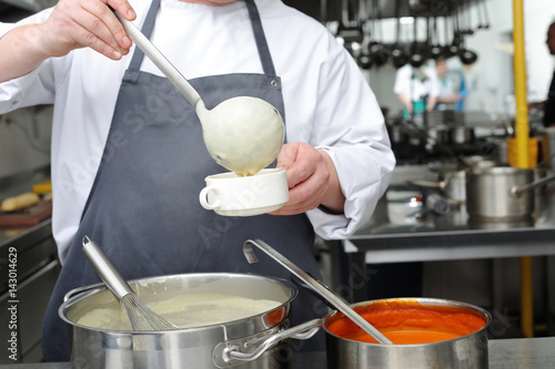 Chef in the kitchen in the restaurant 