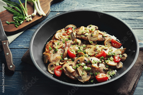 Tasty chicken marsala on pan on table
