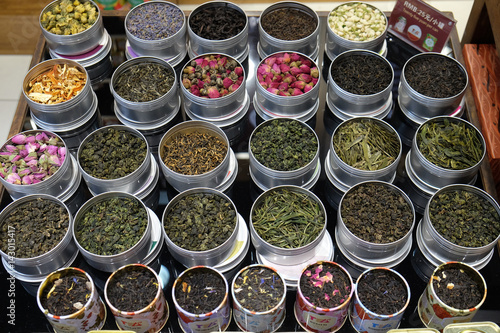 Various types of tea in metal pots exposed for sale in a Chinese tea shop in Shanghai