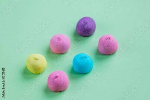 photo of tasty colorful marshmallows on the wonderful green studio background