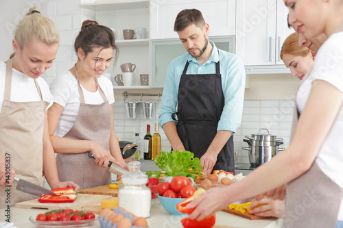 Male chef and group of peop...