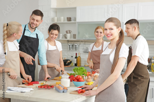 Male chef and group of peop...