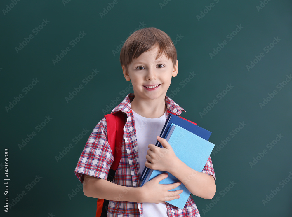 Cute little boy on school blackboard background Cute little boy on school blackboard background