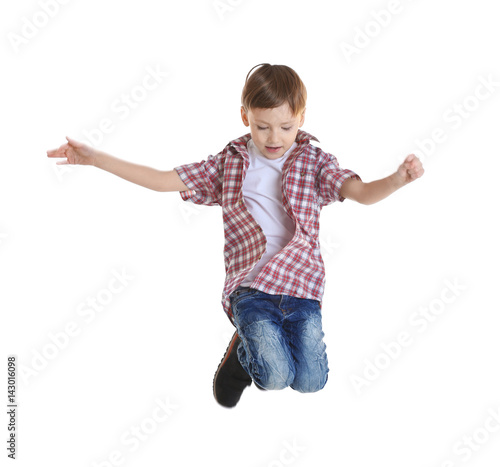 Cute boy jumping on white b...