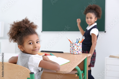 Cute African-American girls in classroom